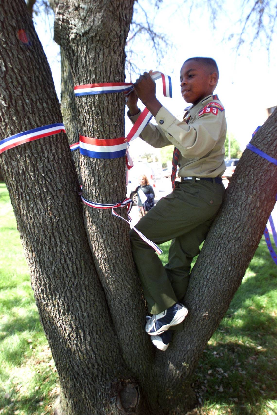 March 24, 2003: L.J. Hopkins, 9, a Webelo, was one of a few youths that started the initiative of tying patriotic ribbons to trees as a show of support for our troops at the Boy Scouts of America National Headquarters in Irving. M.L. GRAY/Fort Worth Star-Telegram