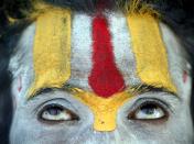 A Sadhu, or Hindu holy man prays after taking a holy dip in the River Ganges in Allahabad, India, Saturday, April 1, 2006. Hindus are observing the nine-days long Navratri festival, or festival of nine nights, dedicated to the three main Hindu Goddesses Parvati, Lakshmi and Saraswati, that began March 30. (AP Photo/Rajesh Kumar Singh)