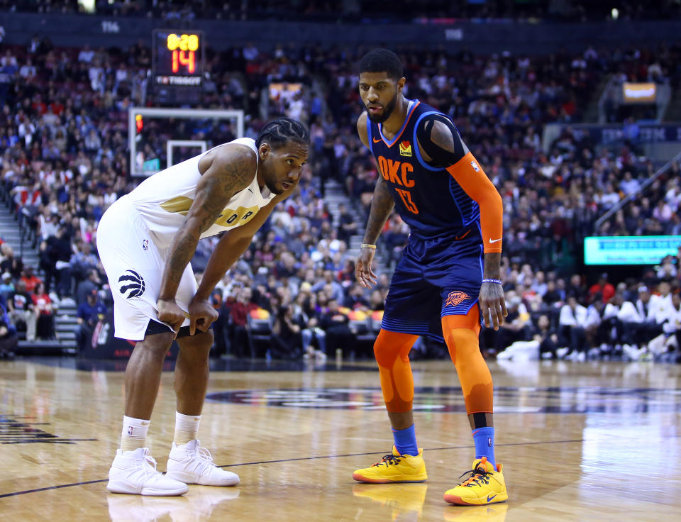 TORONTO, ON - MARCH 22:  Kawhi Leonard #2 of the Toronto Raptors and Paul George #13 of the Oklahoma City Thunder prepare for play to resume during the second half of an NBA game at Scotiabank Arena on March 22, 2019 in Toronto, Canada.  NOTE TO USER: User expressly acknowledges and agrees that, by downloading and or using this photograph, User is consenting to the terms and conditions of the Getty Images License Agreement.  (Photo by Vaughn Ridley/Getty Images)