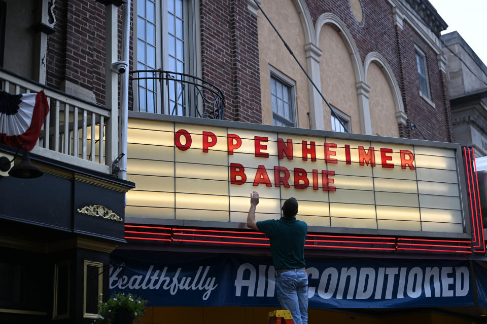 PHOENIXVILLE, PENNSYLVANIA - JULY 16: An employee adds letters for upcoming film releases 