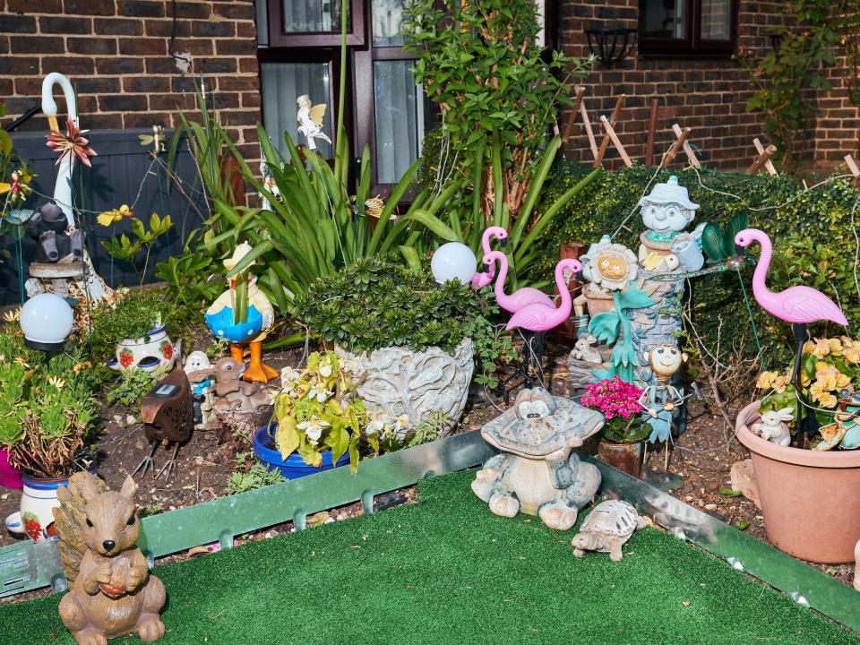 Several lawn ornaments, including cartoonish animals and flamingos, on lawn