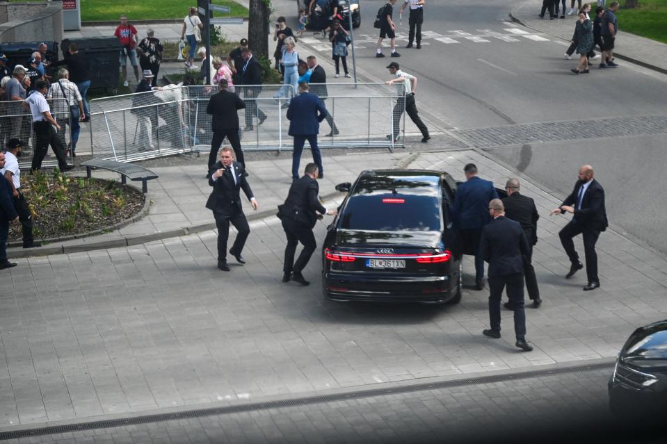 Security officers drag Slovak PM Robert Fico into his official car after the assassination attempt in Handlova (REUTERS)