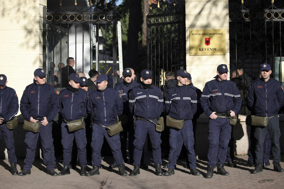 Police guards stand outside the Parliament building during an anti-government rally in Tirana, Albania, Monday, Dec. 18, 2023. Albanian opposition have protested against the government's it accuses of corruption while a parliamentary commission discusses on immunity for its leader Sali Berisha. (AP Photo/Armando Babani)