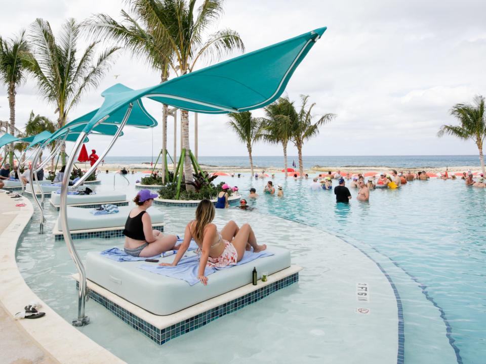people lounging on the pool beds in Royal Caribbean Perfect Day at CocoCay's Hideaway Beach