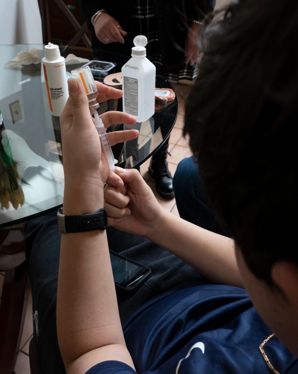 Mar 24, 2023; Millwood, NY, USA; Gianluca Cefalo, 12, of Millwood, NY, pulls a syringe of insulin for use in an Omnipod 5 insulin pump. While the three largest makers of insulin have announced plans to slash prices, the cost of the medication is just one of many expenses people with diabetes must cover.  A dispute between the families health insurer and the company that makes the pump leaves them with a monthly bill of $872 for his care. Mandatory Credit: John Meore-USA TODAY