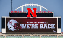 Memorial Stadium's north stadium video board projects the news of the return of Big Ten NCAA college football, Wednesday, Sept. 16, 2020, in Lincoln, Neb. Less than five weeks after pushing fall sports to spring in the name of player safety during the pandemic, the Big Ten conference changed course Wednesday and said it plans to open its football season the weekend of Oct. 23-24. (Francis Gardler/Lincoln Journal Star via AP)