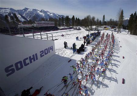 Skiers compete during the women's cross-country 30 km mass start free event at the Sochi 2014 Winter Olympic Games in Rosa Khutor February 22, 2014. Picture taken with multiple exposure. REUTERS/Carlos Barria