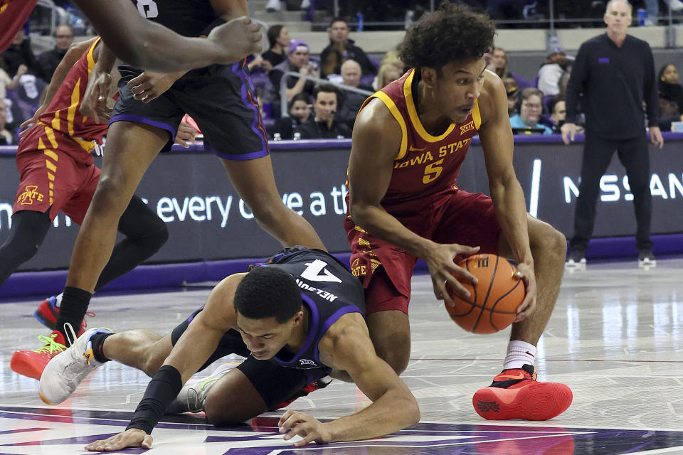 Iowa State guard Curtis Jones (5) gets the ball from TCU guard Jameer Nelson Jr. (4) in the first half of an NCAA basketball game Saturday, Jan. 20, 2024, in Fort Worth, Texas. (AP Photo/Richard W. Rodriguez)