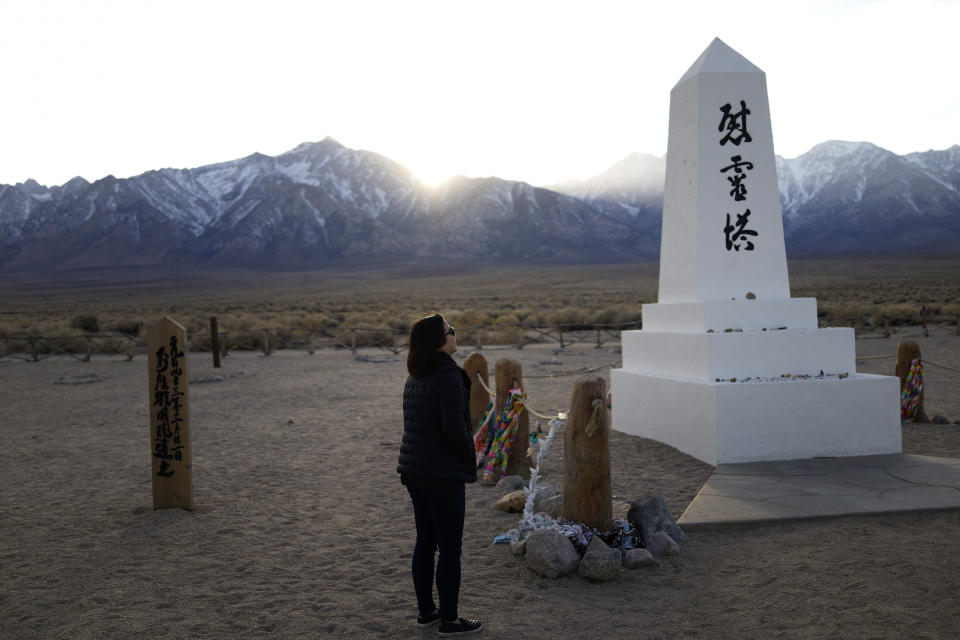 FILE - In this Feb. 17, 2020, file photo Lori Matsumura visits the cemetery at the Manzanar National Historic Site near Independence, Calif. The auction of a series of sketches purportedly drawn by an artist at the Japanese internment camp has been canceled Tuesday, April 6, 2021, after groups protested it was offensive and immoral to profit off the misery of incarcerated people. Matsumura, the granddaughter of Giichi who recently reburied her grandfather's remains after a hiker unearthed his skeleton in 2019, thought the sketches could be by her late father, Masaru, or another family member. (AP Photo/Brian Melley, File)