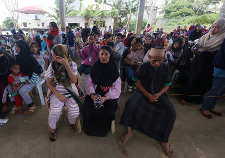 Residents staying at evacuation centers, due to the assault of government troops against pro-Islamic State militant groups, wait for their names to be called before being allowed to return home, at an open gym in Basak, Malutlut district in Marawi city, southern Philippines October 29, 2017. REUTERS/Romeo Ranoco