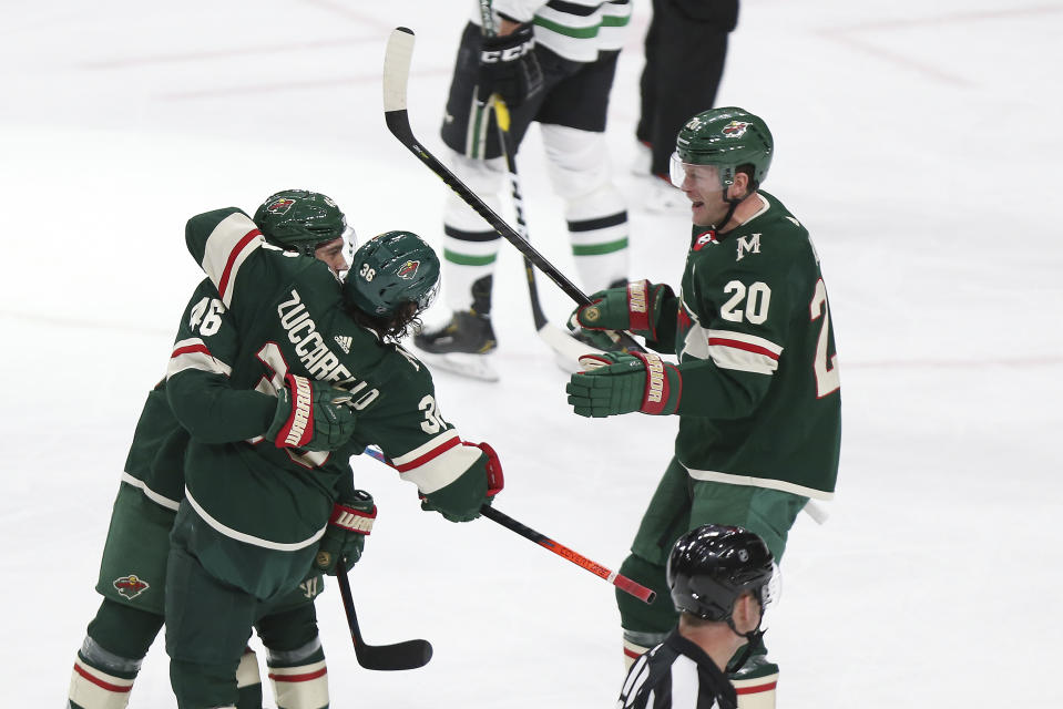 Minnesota Wild's Jared Spurgeon hugs teammate Mats Zuccarello after Spurgeon scored a goal against the Dallas Stars in the first period of an NHL hockey game Saturday, Jan. 18, 2020, in St. Paul, Minn. (AP Photo/Stacy Bengs)