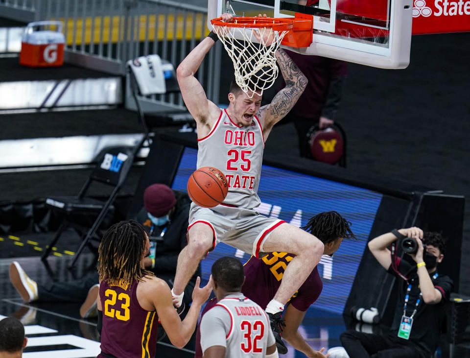 FILE - In this March 11, 2021, file photo, Ohio State forward Kyle Young (25) dunks over Minnesota center Sam Freeman (32) in the first half of an NCAA college basketball game at the Big Ten Conference tournament in Indianapolis. Ohio State opens on Nov. 9 against Akron, welcoming back fans to Value City Arena for the first time since 2019. (AP Photo/Michael Conroy, File)