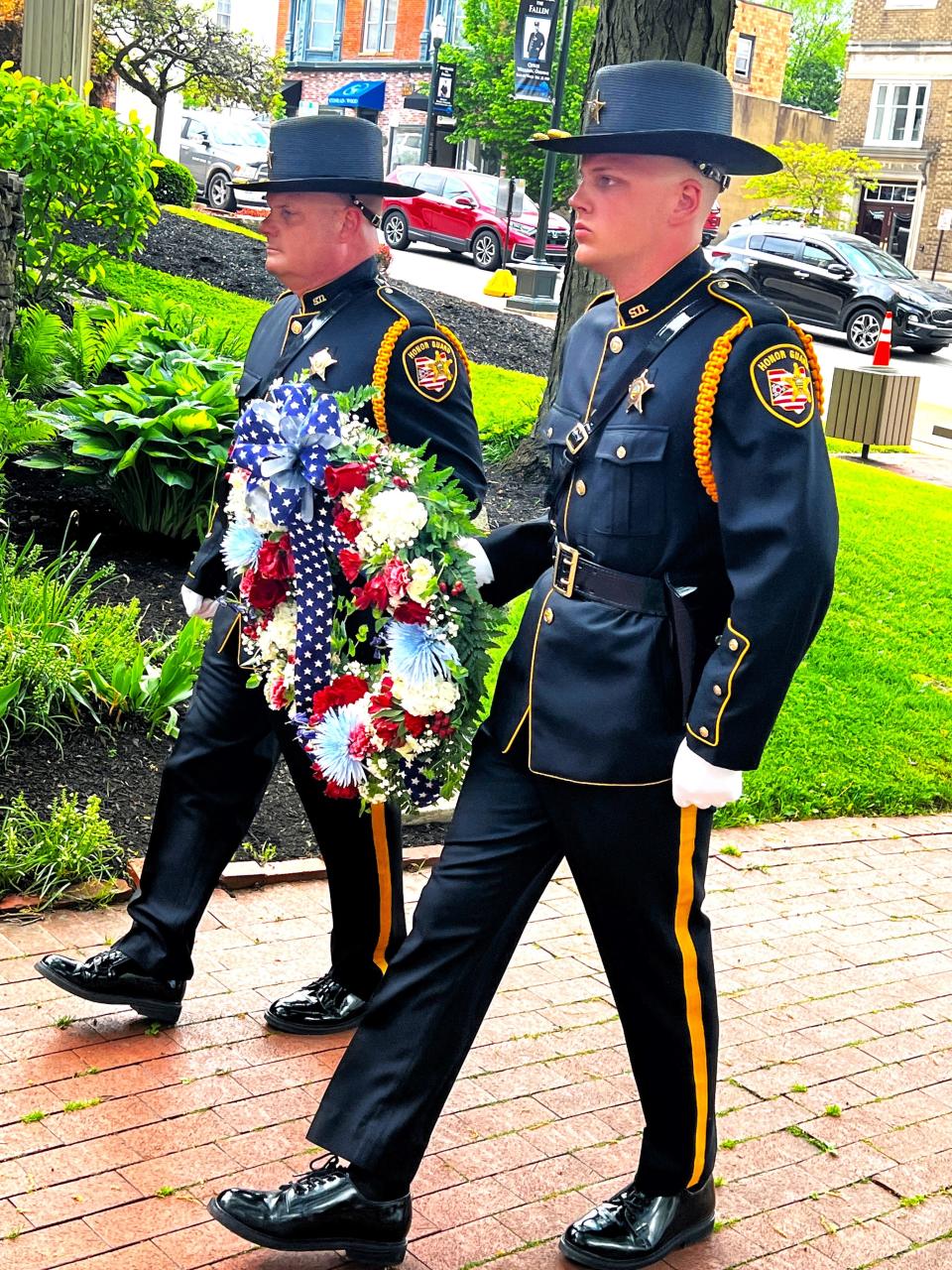 Fairfield County Sheriff honor guard members carry the wreath honoring law enforcement officers who lost their lives in the line of duty at Friday's annual law enforcement memorial ceremony. The event was near the downtown bandstand at Main and Broad streets.