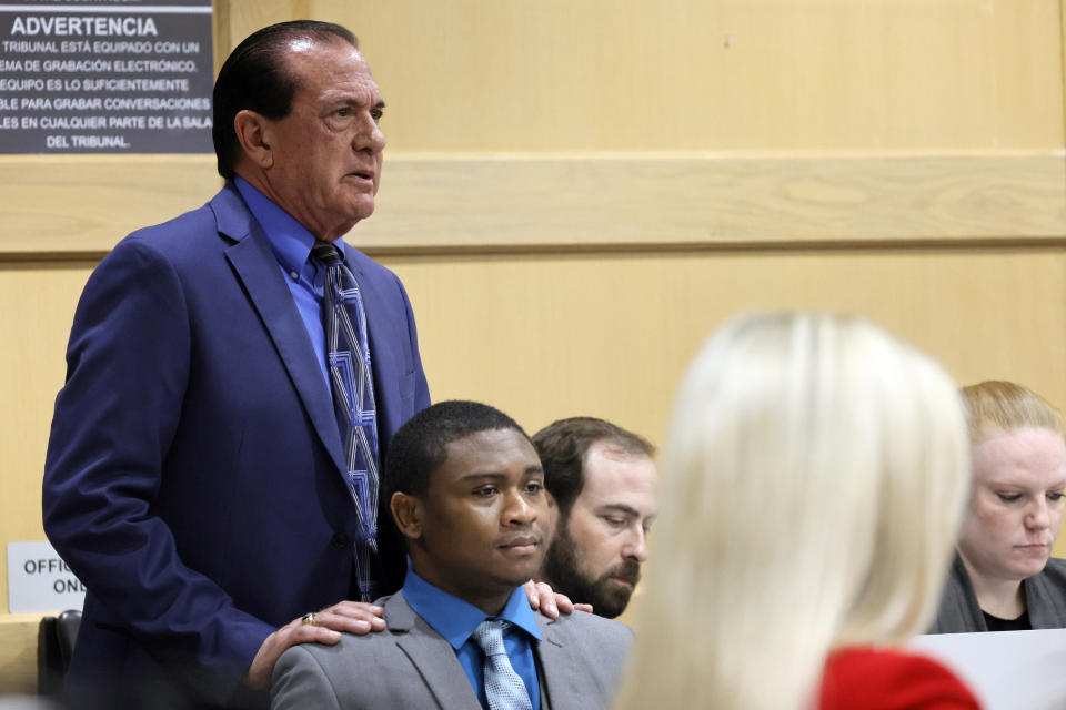 George Edward Reres puts his hands on the shoulders of his client, Trayvon Newsome, as he begins his closing argument in the XXXTentacion murder trial at the Broward County Courthouse in Fort Lauderdale, Fla., Tuesday, March 7, 2023. Emerging rapper XXXTentacion, born Jahseh Onfroy, 20, was killed during a robbery outside of Riva Motorsports in Pompano Beach in 2018, allegedly by defendants Michael Boatwright, Newsome, and Dedrick Williams. (Amy Beth Bennett/South Florida Sun-Sentinel via AP, Pool)