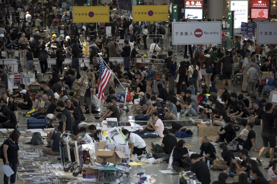 Protesters stage a sit-in rally at the arrival hall of the Hong Kong International Airport in Hong Kong, Tuesday, Aug. 13, 2019. (Photo: Vincent Thian/AP)