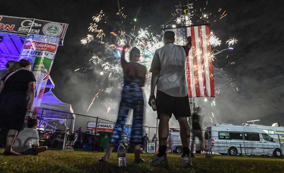 Brian Mims, right, holds up his hand with daughter Ava Mims of Anderson, celebrating during the 4th of July Freedom Celebration Fireworks and Concert in Williamston, S.C. Saturday, June 29, 2024. 