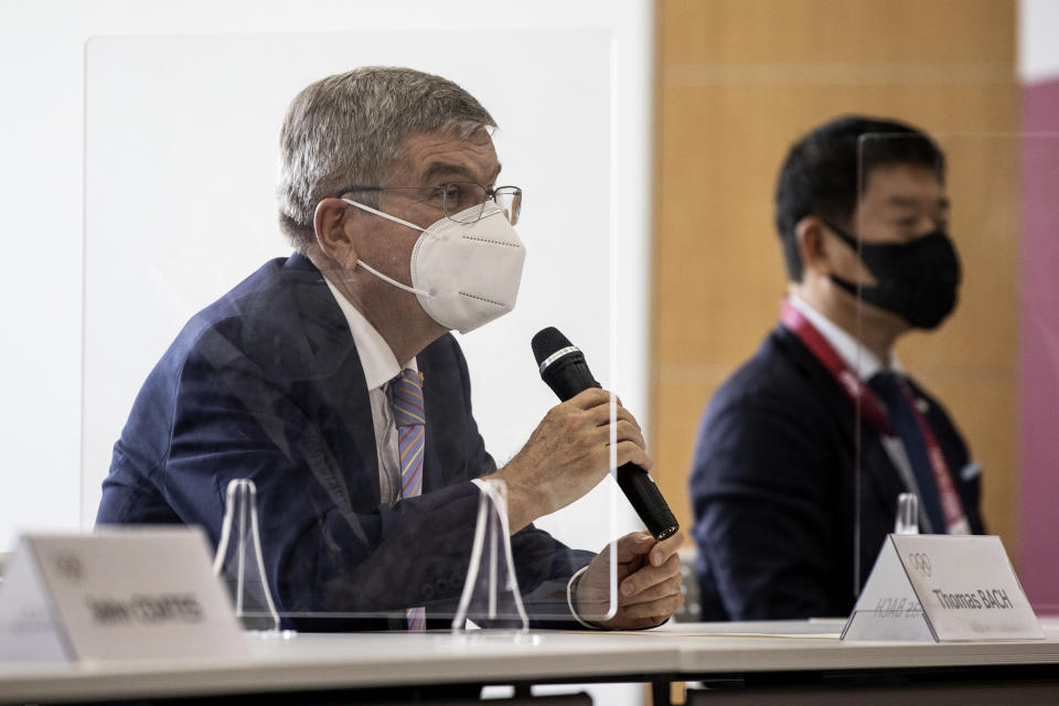 IOC President Thomas Bach, left, speaks to Tokyo 2020 President Seiko Hashimoto, not in photo, during their meeting at the Tokyo 2020 Headquarters Tuesday, July 13, 2021 in Tokyo, Japan. Bach appeared in public on Tuesday for the first time since arriving in Tokyo last week with the pandemic-postponed Olympics opening in just 10 days. (Takashi Aoyama/Pool Photo via AP)