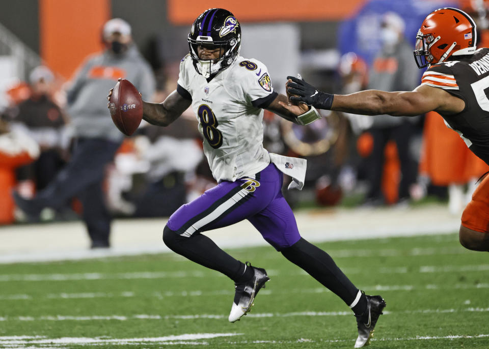 Baltimore Ravens quarterback Lamar Jackson (8) scrambles during the first half of an NFL football game against the Cleveland Browns, Monday, Dec. 14, 2020, in Cleveland. (AP Photo/Ron Schwane)