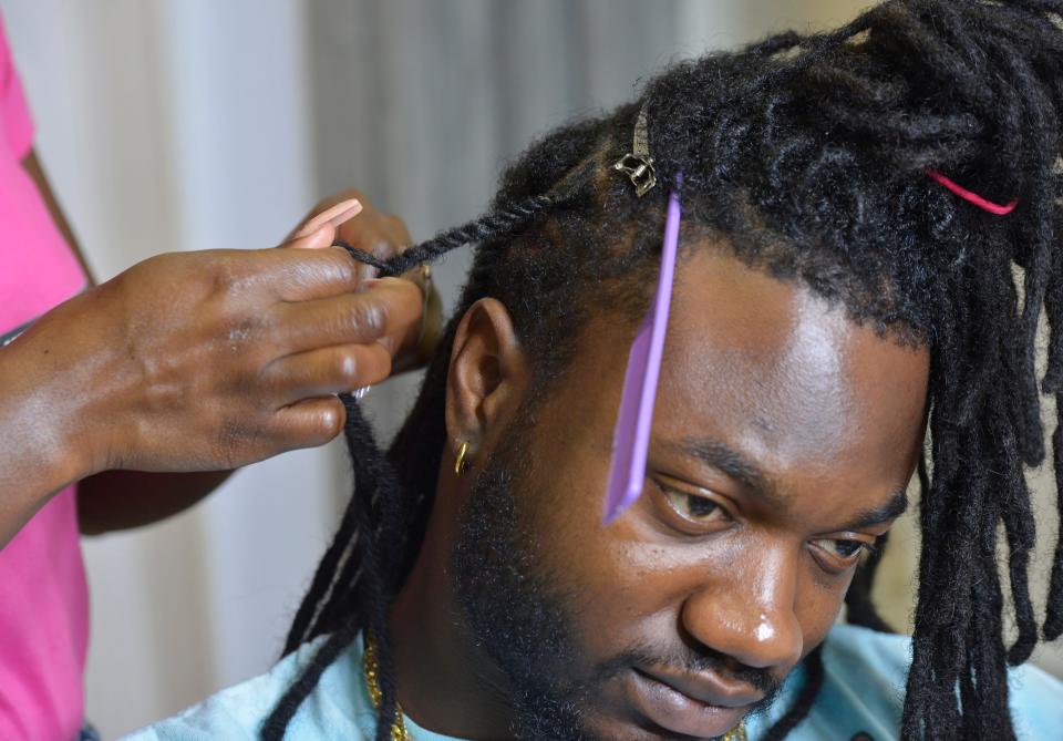 Kenard Smith is having his dreadlocks re-twisted by his sister Keniqua Smith at Divas Beauty Studio in Hyannis. Keniqua Smith recommends those with dreadlocks get them re-twisted every three weeks.