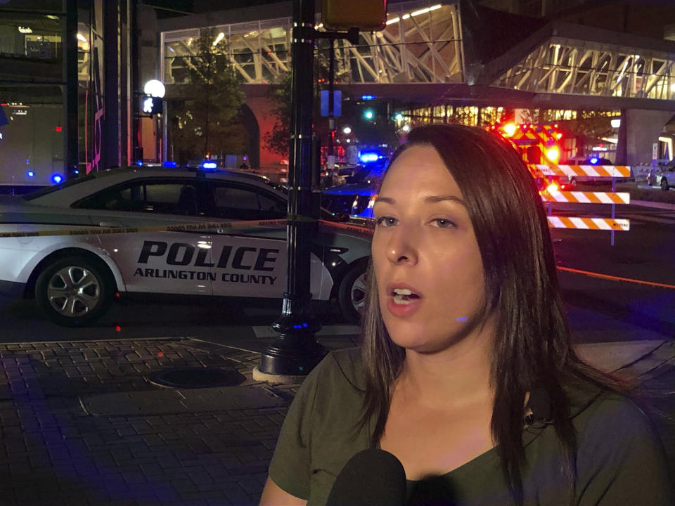 Arlington County Police spokeswoman Ashley Savage briefs reporters on a report of a shooting at a movie theater in Ballston Quarter mall, Saturday, Sept. 14, 2019, in Arlington, Va. Police responded but found no evidence of a shooting in their preliminary investigation. (AP Photo/Matthew Barakat)