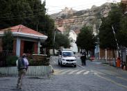 A man stands next to the entrance of the Urbanizacion La Rinconada where is it located the Mexico's ambassador residence in La Paz