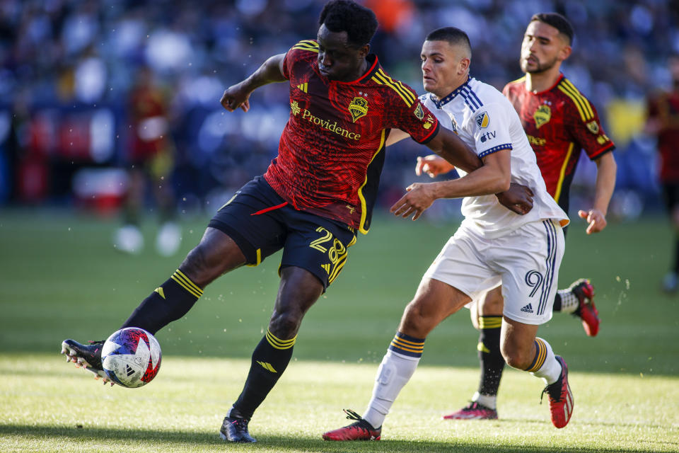 Seattle Sounders defender Yeimar Gomez Andrade (28) controls the ball while defended by LA Galaxy forward Dejan Joveljic (9) during the second half of an MLS soccer match in Carson, Calif., Saturday, April1, 2023. (AP Photo/Ringo H.W. Chiu)