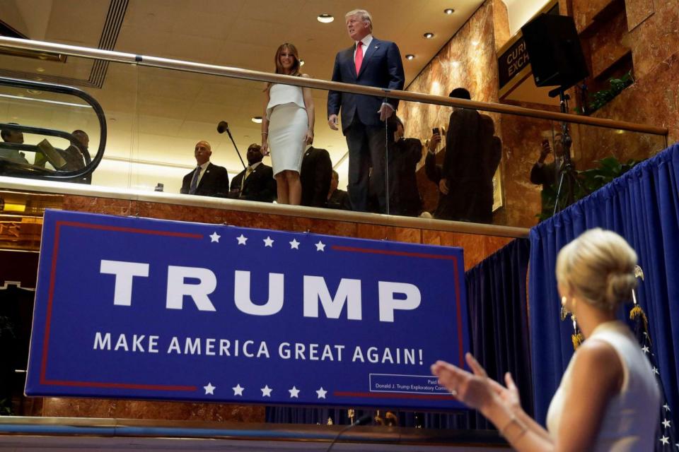 PHOTO: Donald Trump and wife Melania Trump, is applauded by his daughter Ivanka Trump, right as he's introduced before his announcement that he will run for president in the lobby of Trump Tower in New York, June 16, 2015. (Richard Drew/AP)