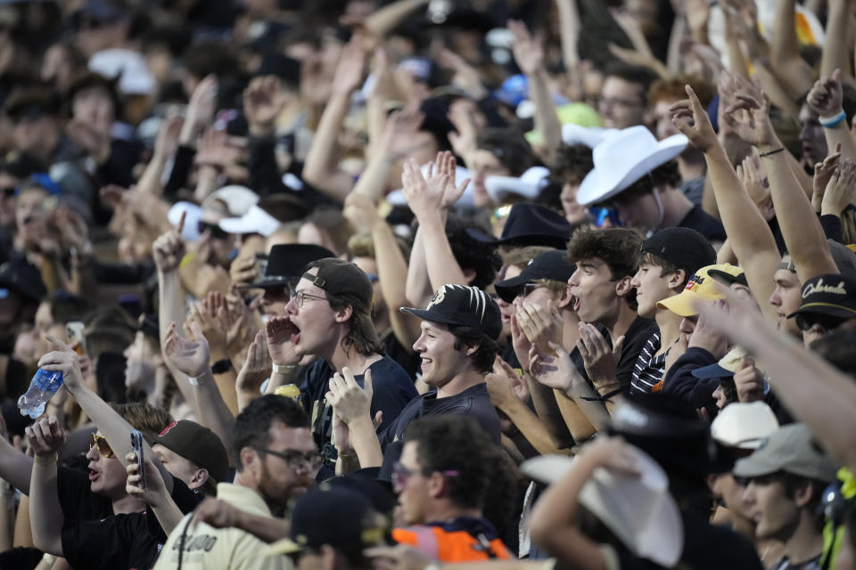 Colorado fans cheer as players warm up before an NCAA college football game against Colorado State, Saturday, Sept. 16, 2023, in Boulder, Colo. (AP Photo/David Zalubowski)