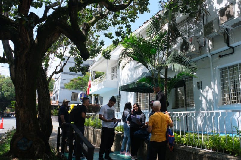 People wait to be called inside with their documents at the new Venezuelan consulate in Medellin, Colombia, on Tuesday. Appointments must first be booked online. Photo by Austin Landis/UPI