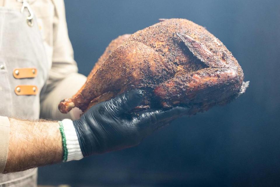 Brandon Hurtado pulls a turkey out of the smoker Monday, Oct. 31, 2022, at Hurtado Barbecue in Fort Worth.