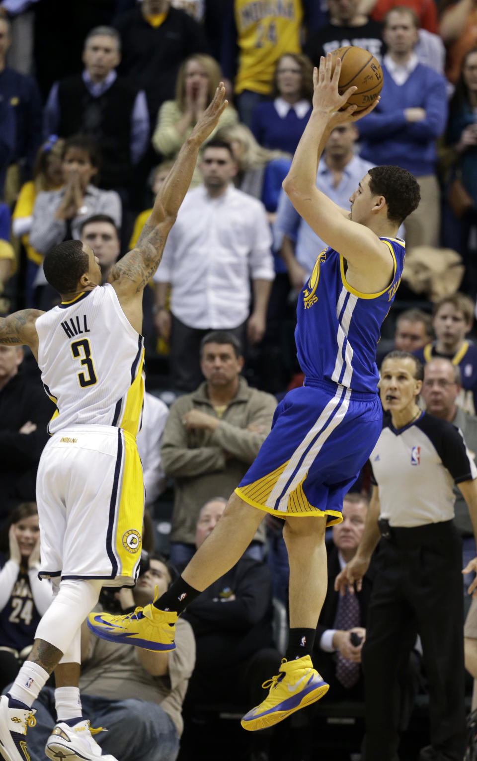 Golden State Warriors' Klay Thompson (11) puts up the game winning shot against Indiana Pacers' George Hill (3) during the second half of an NBA basketball game Tuesday, March 4, 2014, in Indianapolis. Golden State defeated Indiana 98-96. (AP Photo/Darron Cummings)