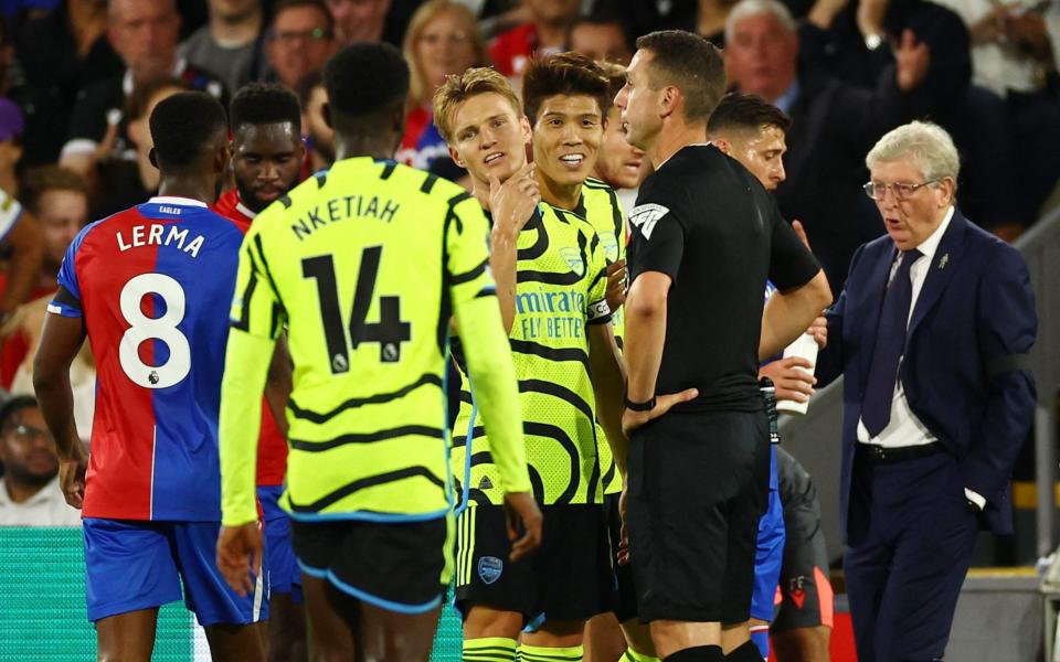Arsenal's Takehiro Tomiyasu reacts after being sent off by referee David Coote