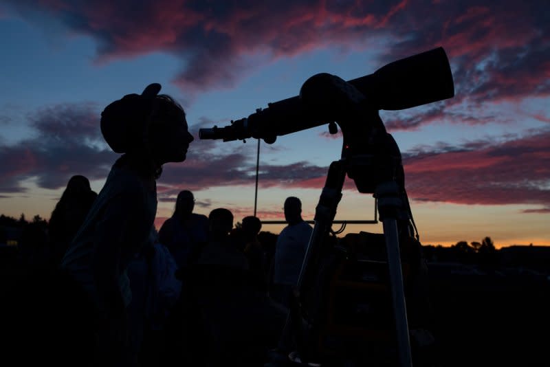 A student peers through a telescope at a star party held at Madras High School the night before crowds come to watch the total solar eclipse in Madras, Ore., on August 20. On August 25, 1609, Galileo Galilei exhibited his first telescope in Venice. Photo by Aubrey Gemignani/UPI