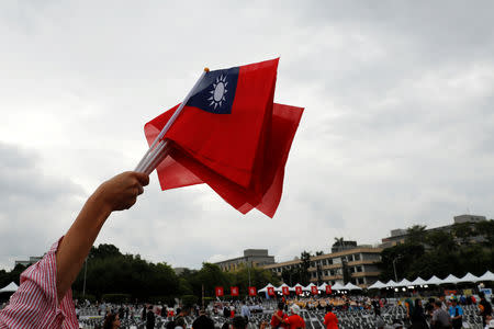 An audience waves Taiwanese flags during the National Day celebrations in Taipei, Taiwan October 10, 2018. REUTERS/Tyrone Siu