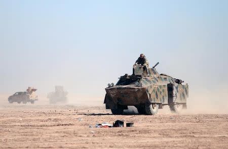 A Syrian Democratic Forces (SDF) fighters sits on a vehicle in the north of Raqqa city, Syria February 3, 2017. Picture taken February 3,2017. REUTERS/Rodi Said