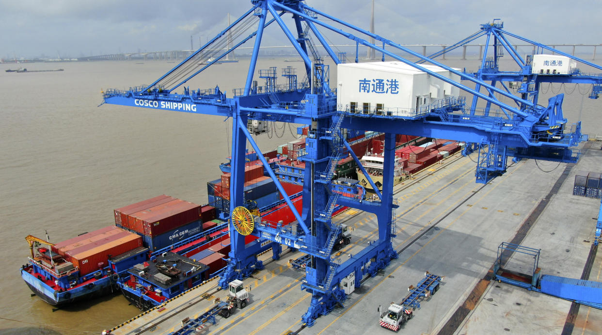 FILE - In this July 18, 2019, file photo, shipping containers are loaded onto a cargo ship at a port in Nantong in eastern China&#39;s Jiangsu province. Beijing appealed to Washington on Wednesday, Aug. 21, to &quot;meet China halfway&quot; and end a tariff war after President Donald Trump said Americans might need to endure economic pain to achieve longer-term benefits. (Chinatopix via AP)