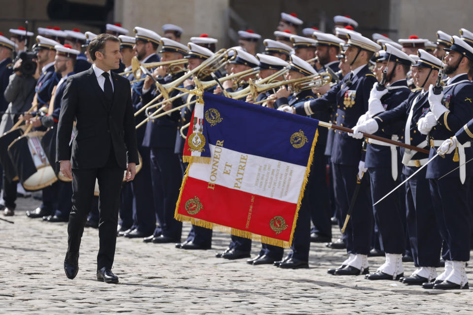 France's President Emmanuel Macron reviews troops during a tribute ceremony to late French politician and admiral Philippe de Gaulle, the son of Charles de Gaulle, at the Hotel des Invalides in Paris, March 20, 2024. / Credit: LUDOVIC MARIN/POOL/AFP/Getty