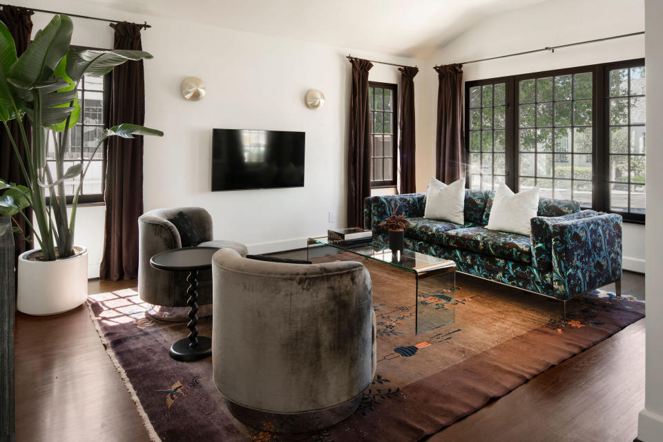 a white-walled living room with grey sofas