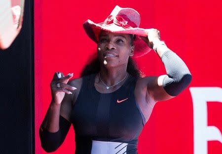 Serena Williams of the U.S. wears a hat as she signs autographs at the Australian Open tennis tournament in Melbourne, Australia in this handout image taken January 25, 2017. Fiona Hamilton/Courtesy of Tennis Australia/Handout via REUTERS/files