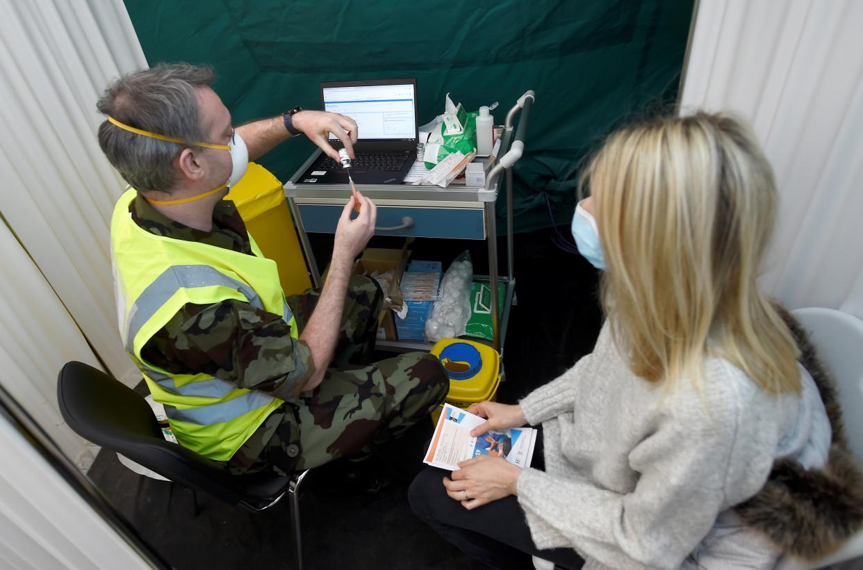 <p>A vaccinator in Dublin prepares a dose of the AstraZeneca jab</p> (Reuters)