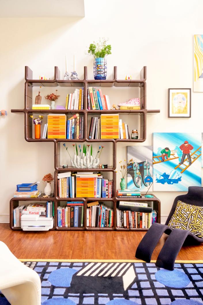 The couple found their dream Umbo shelf, Joel says, by “trolling eBay for years.” Bouloum chair by Olivier Mourgue. Rug designed by Nathalie du Pasquier for La Chance.