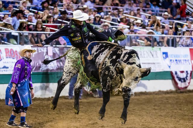 <p>Ty O'Neil/SOPA Images/LightRocket via Getty </p> JB Mauney rides a bull becoming the 2021 Reno Rodeo champion