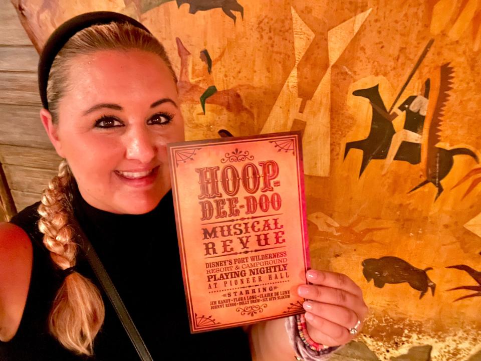 Hoop-De-Doo Revue at Disney - the writer holding a small poster for the show