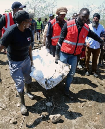 Kenya Red Cross workers carry the body of a visitor who died in flash floods while on an excursion at the Hell's Gate National Park in Naivasha