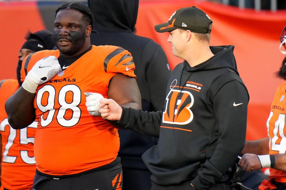 Cincinnati Bengals head coach Zac Taylor fist bumps Cincinnati Bengals nose tackle D.J. Reader (98) in the game against the Pittsburgh Steelers Nov. 28. The Cincinnati Bengals won, 41-10.