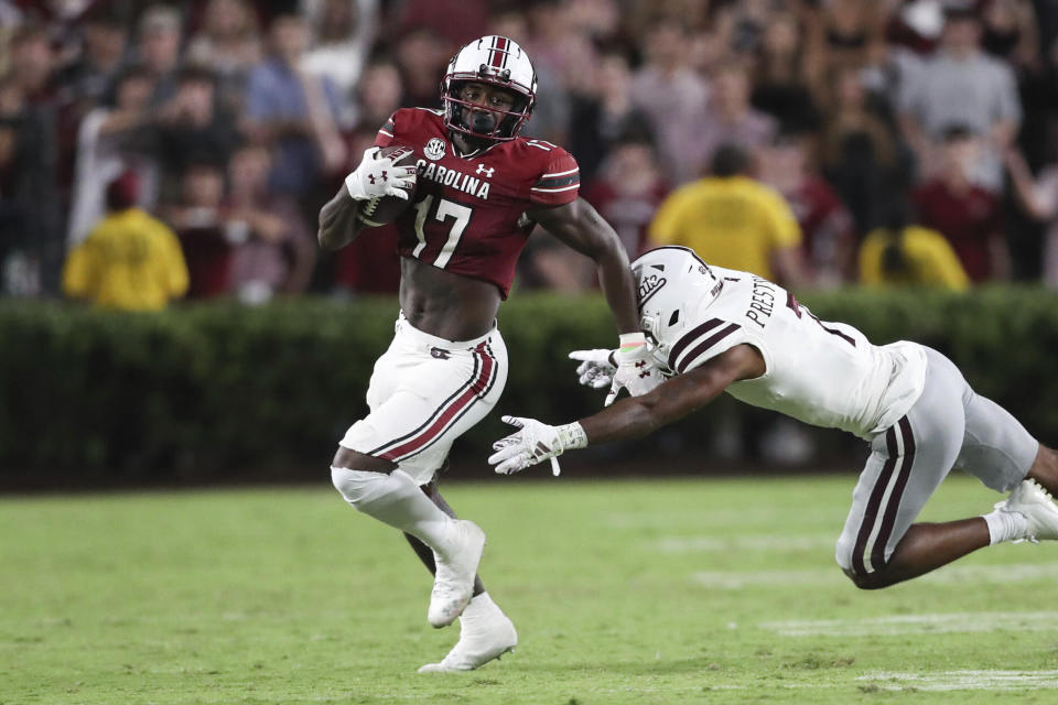 FILE - South Carolina wide receiver Xavier Legette (17) runs away from Mississippi State safety Shawn Preston Jr. (7) during the second half of an NCAA college football game on Saturday, Sept. 23, 2023, in Columbia, S.C. South Carolina's best playmakers on offense the past two years are all gone, meaning this spring is a search for consistency and production from an attack that had its struggles last season. With Spencer Rattler and Legette awaiting NFL draft picks — Legette a likely first-rounder, Rattler a mid-round choice — it's up to inexperienced newcomers and transfers to push the Gamecocks forward. (AP Photo/Artie Walker Jr., File)