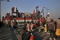 Anti-government protesters gather on the closed Joumhouriya Bridge that leads to the Green Zone government areas in Baghdad, Iraq, Sunday, Oct. 25, 2020. (AP Photo/Khalid Mohammed)