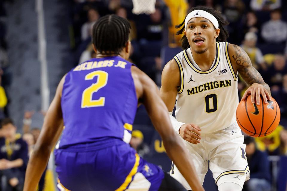 Michigan Wolverines guard Dug McDaniel (0) dribbles defended by McNeese State Cowboys guard DJ Richards Jr. (2) in the first half at Crisler Center in Ann Arbor on Friday, Dec. 29, 2023.