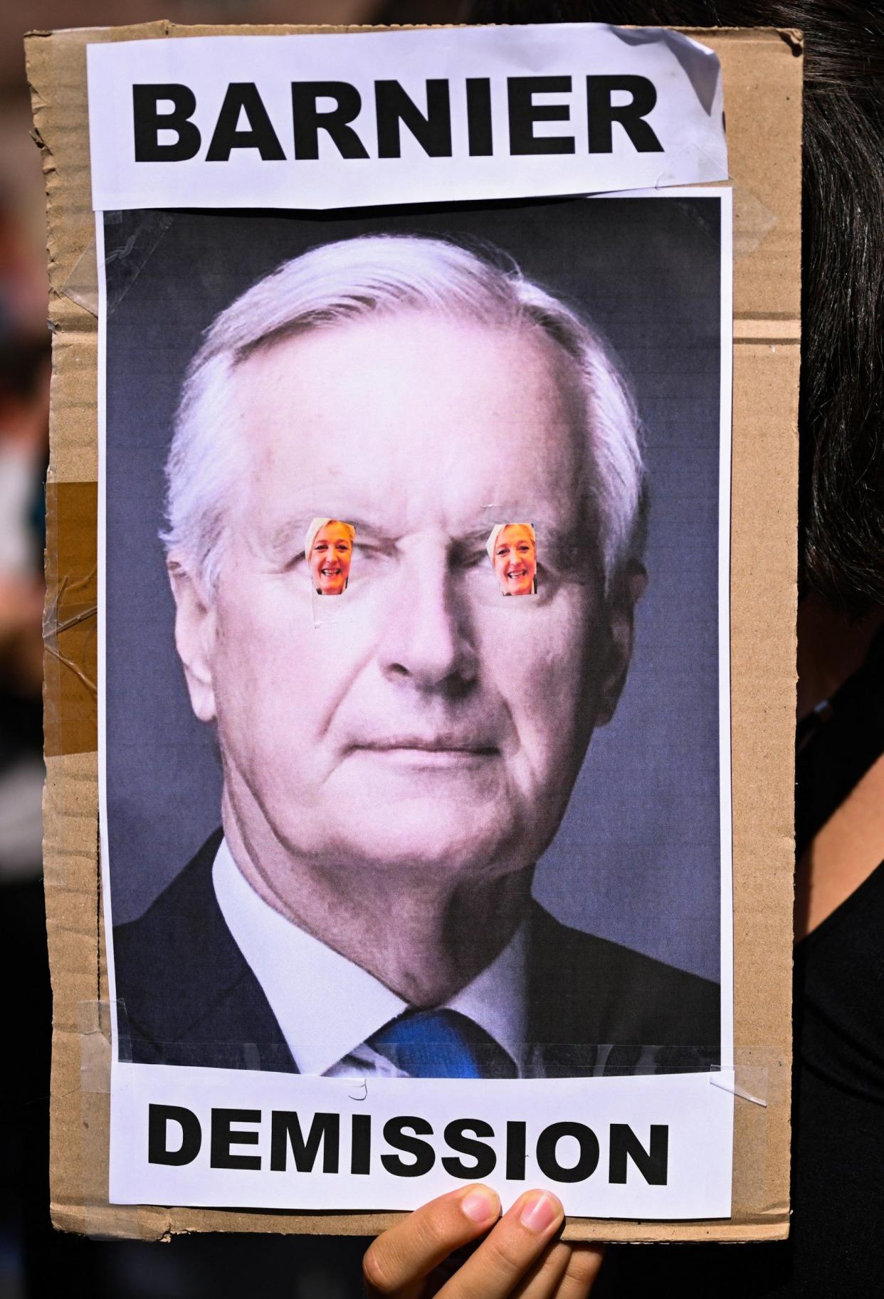 A placard reading 'Barnier resign'