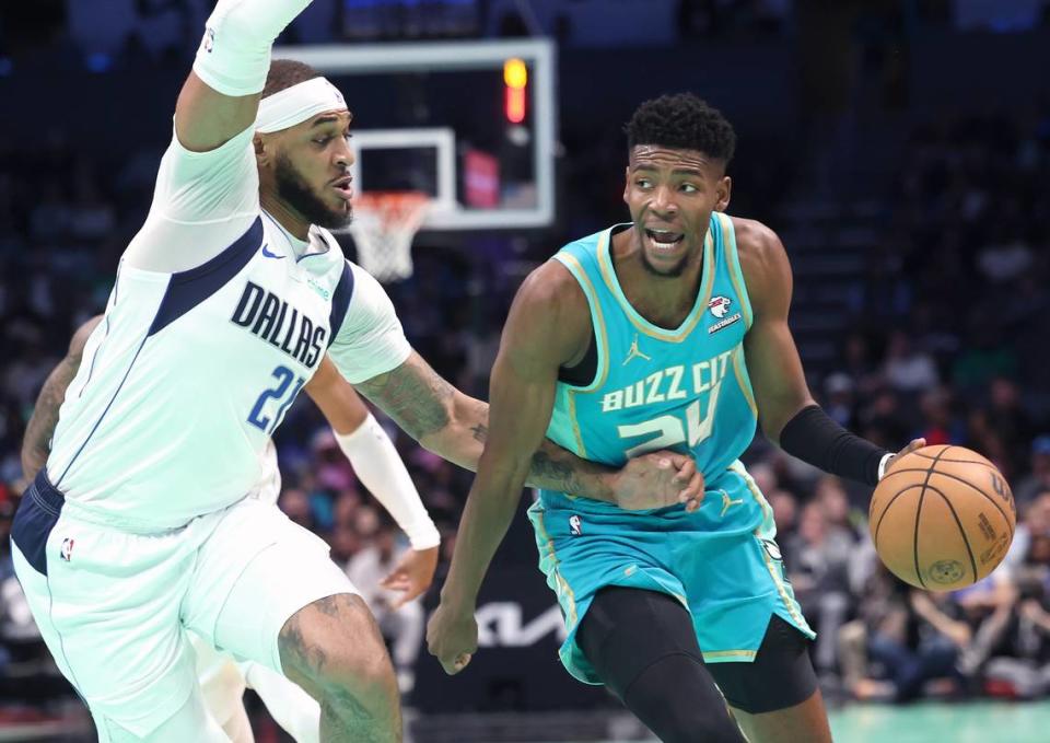 Charlotte Hornets forward/guard Brandon Miller, right, looks to drive into the lane as Dallas Mavericks center Daniel Gafford, left, applies defensive pressure during first-half action at Spectrum Center in Charlotte, NC on Tuesday, April 9, 2024. The Mavericks defeated the Hornets 130-104.